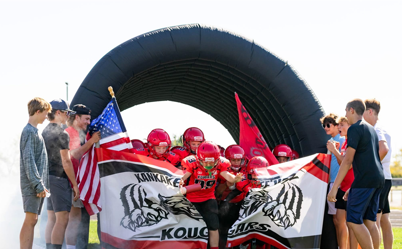 High School Football Team Holding our Banners at a Home Game 2025